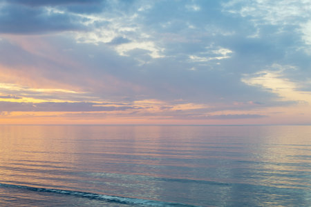 Calm water on sea surfase. Beautiful colorful sunset over Baltic sea in Jurmala resort, Latvia. Relax, vacation concept.の写真素材