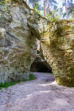 Arch in rock. View of sandstone cliff Big Elita in sunny day. Beautiful Latvia natural background.の写真素材