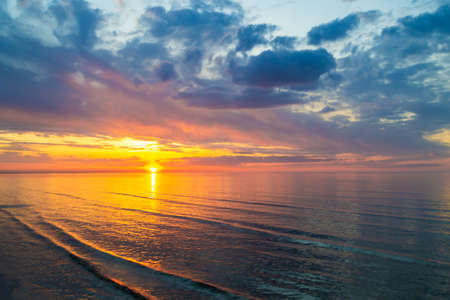 Colorful clouds on sunset, with beautiful reflection on sea water. Evening summer scenery view. Baltic Sea in Jurmala resort, Latvia.の写真素材