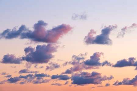 Many little clouds on orange - blue sky background. Dramatic sky during sunset. Latvia natureの写真素材
