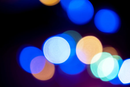 Multicolored circle bokeh defocused light. Christmas twinkling lights background bokeh. New year...