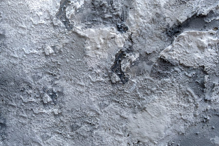 Gray plaster texture with silver and white spots. Cement wall background. Copy space.
