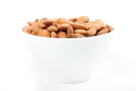 Bowl with almonds on a white background.の写真素材