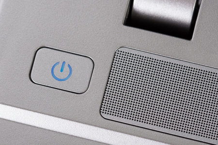 Metallic power button on a laptop 