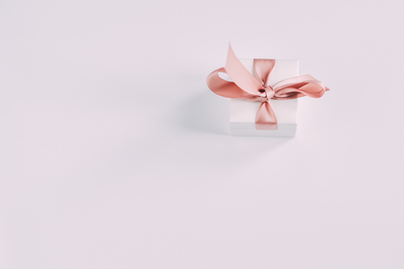 Close up shot a small gift wrapped with pink ribbonの写真素材