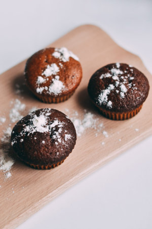 Homemade delicious chocolate muffins close-up,vertical, top view