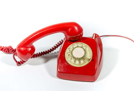 is an old red phone on a white backgroundの写真素材