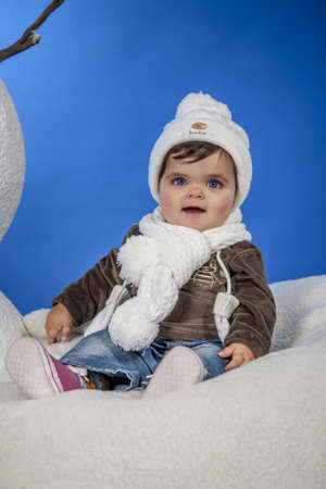 is a baby with a hat and scarf の写真素材