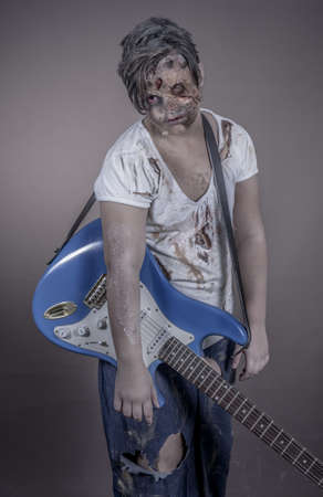 is a girl disguised as a zombie with a guitarの写真素材