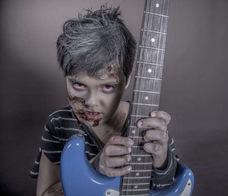 is a girl disguised as a zombie with a guitarの写真素材