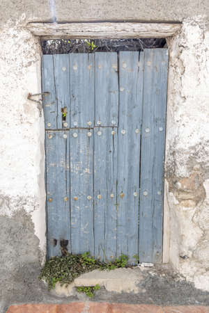 is an old wooden door blue and abandonedの写真素材
