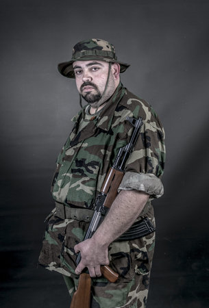 is a soldier wearing his uniform and gun