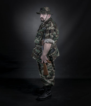 is a soldier wearing his uniform and gun