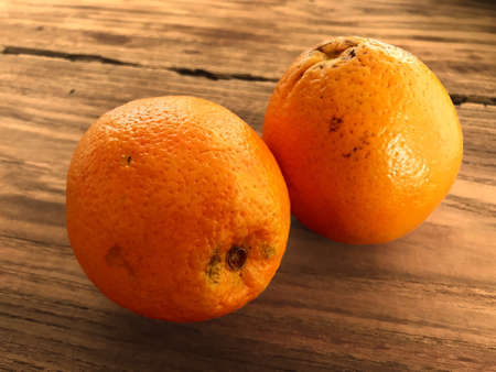 Close up of two oranges on a wooden tableの写真素材