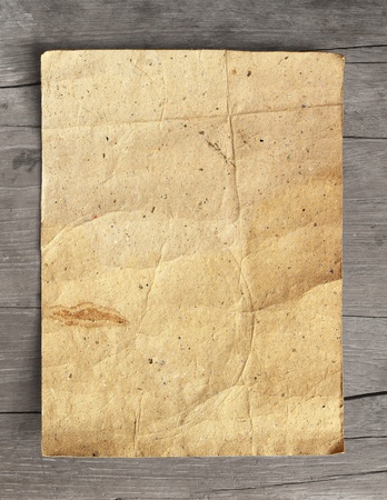 Crumpled grunge paper on wooden backgroundの写真素材
