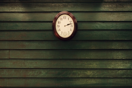 Old wooden wall with clockの写真素材