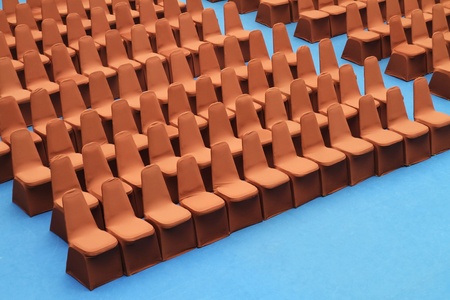 Brown seats on blue carpet in the convention hallの写真素材