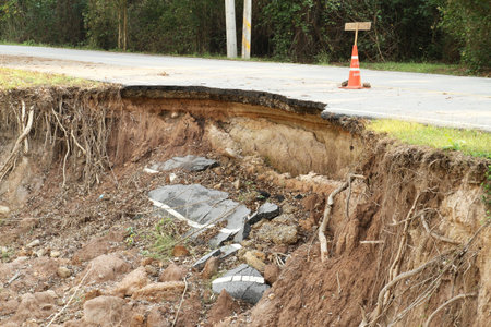 Broken asphalt road by landslide