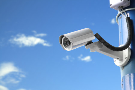 Security camera on blue sky background