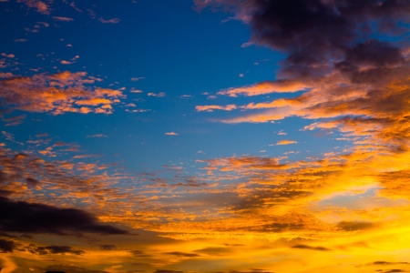 Blue sky with orange cloud at twilightの写真素材