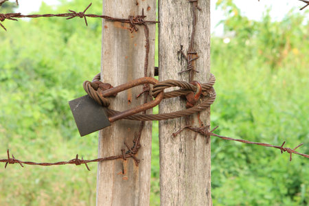 Rusty locked with sling on old wooden doors