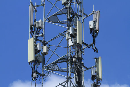 Telecommunication tower 4G 5G antenna on blue skyの写真素材