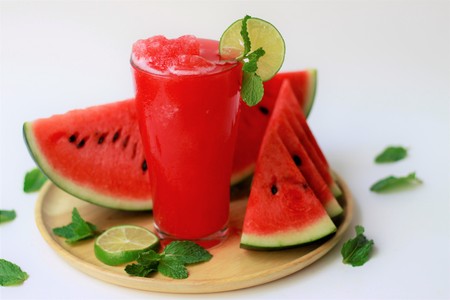 Healthy watermelon smoothie with lime and mint leave on white backgroundの写真素材