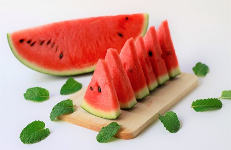Slices of  juicy watermelon on a wooden plate-summer fruits-summertimeの写真素材