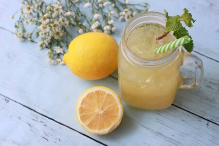 Lemonade  with mint leaves and lemons on wooden bakground, Summer cocktails and drinksの写真素材