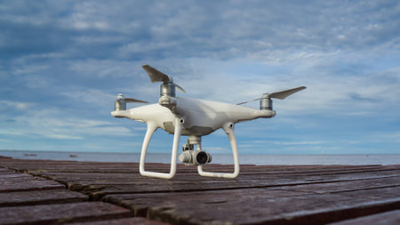 White Drone prepare to fly, take off to the ocean in thailand