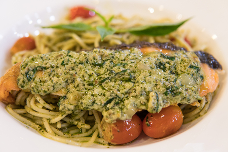 Spicy salmon Spaghetti carbonara on white plateの写真素材