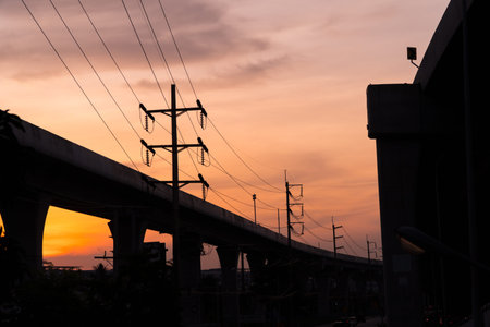 landscape with high-voltage poles at sunset