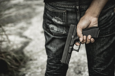 A man holding a gun in hand, the ship ready to shoot the man pointed a gun at us. A man holding a...