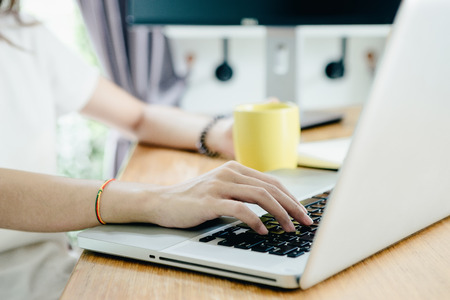 Young asian girl is freelancer with her private business at home office, working with laptop, coffee, online marketing, Customer order and packaging or packing.の写真素材