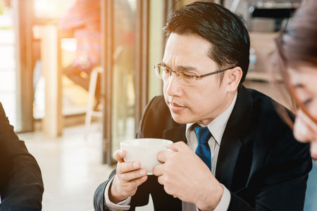 A group of men are businessmen sit together and succeeded in finding the various agreements.の写真素材