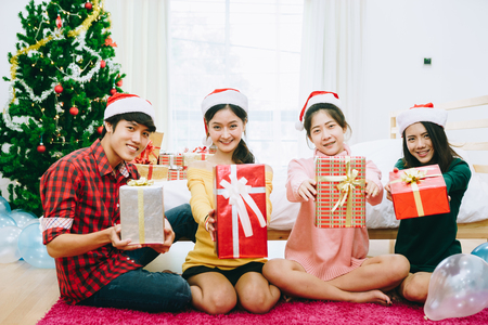 Young Asian teens are decorating the Christmas tree and party at their home. BCE to celebrate the coming 2018.の写真素材