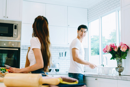 Asian teen couple are helping to make dinner. And bakery together happily. On Valentine's Day in their home.の写真素材