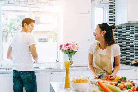 Asian teen couple are helping to make dinner. And bakery together happily. On Valentine's Day in their home.の写真素材