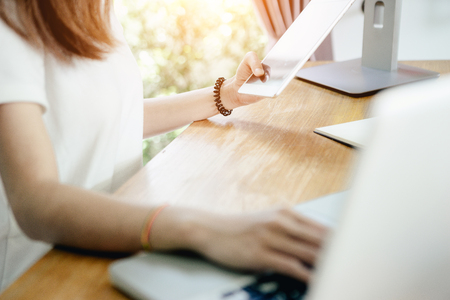 Young asian girl is freelancer with her private business at home office, working with laptop, coffee, online marketing, Customer order and packaging or packing.の写真素材