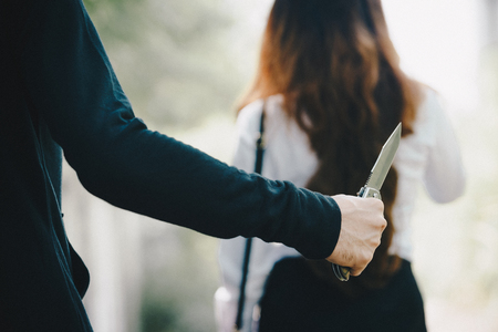 Thieves were threatened with a knife office girl on the way she was walking home.の写真素材