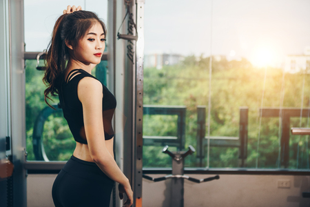 Asian woman exercising in the gym, Young woman workout in fitness for her healthy and office girl lifestyle.の写真素材