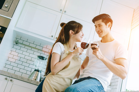 Asian teen couple are helping to make dinner. And bakery together happily. On Valentine's Day in their home.の写真素材