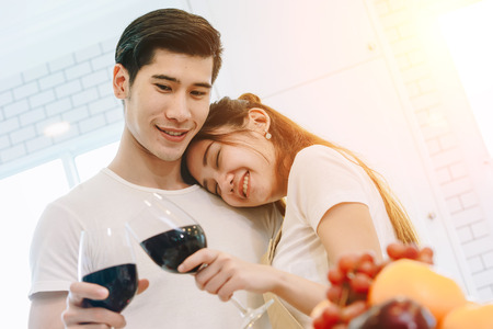 Asian teen couple are helping to make dinner. And bakery together happily. On Valentine's Day in their home.の写真素材