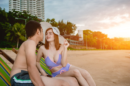 Asian couple walking on the beach when the sun is about to sunset during the honeymoon. There are  Couple walking on Valentine's Dayの写真素材