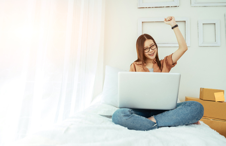 Young asian girl is freelancer with her private business at home office, working with laptop, coffee, online marketing. Young woman startup her SME business.の写真素材
