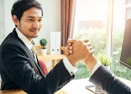 Business man and office concenpt. two man are hand shaking by each other.の写真素材