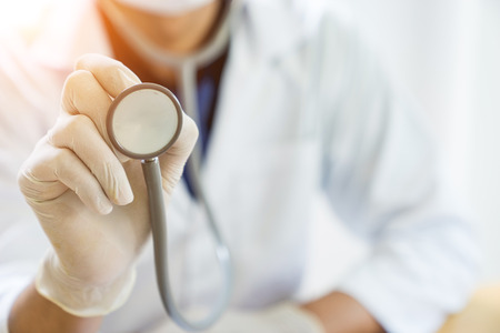 A doctor is working in the hospital, he is wearing a brown stethoscope for check his partient.の写真素材