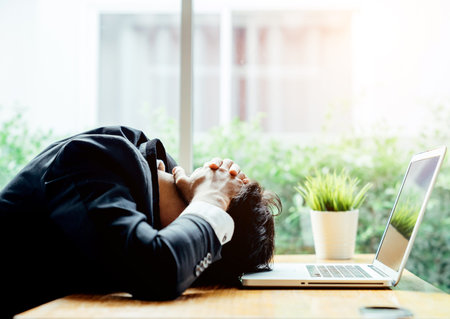 Asian businessman man depressed because he was in trouble in the business he is handle in progress.