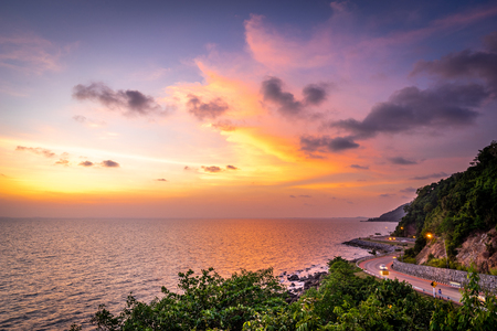 The seaside road adjacent to the mountain at sunset on the east side of Thailand.の写真素材