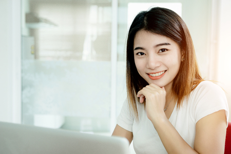 Young asian girl is freelancer with her private business at home office, working with laptop, coffee, online marketing, Customer order and packaging or packing.の写真素材